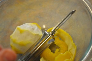 Use a peeler to spiral-peel each lemon