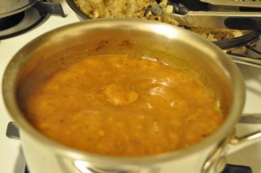 Simmering gravy, still with unincorporated bits of flour floating