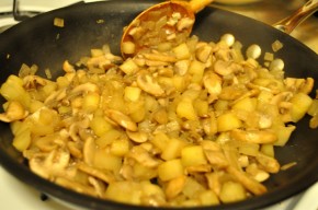 Sautéing onions, yellow carrots, and mushrooms