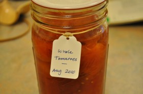 A jar of home-canned tomatoes from last summer